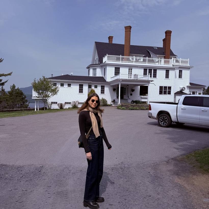 Camel scarf and dark denim in front of a white clapboard inn