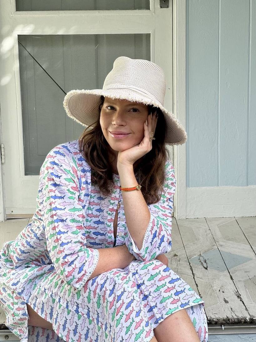 Smiling in a sun hat and printed kaftan